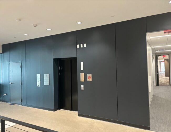 Painted black elevator lobby wall